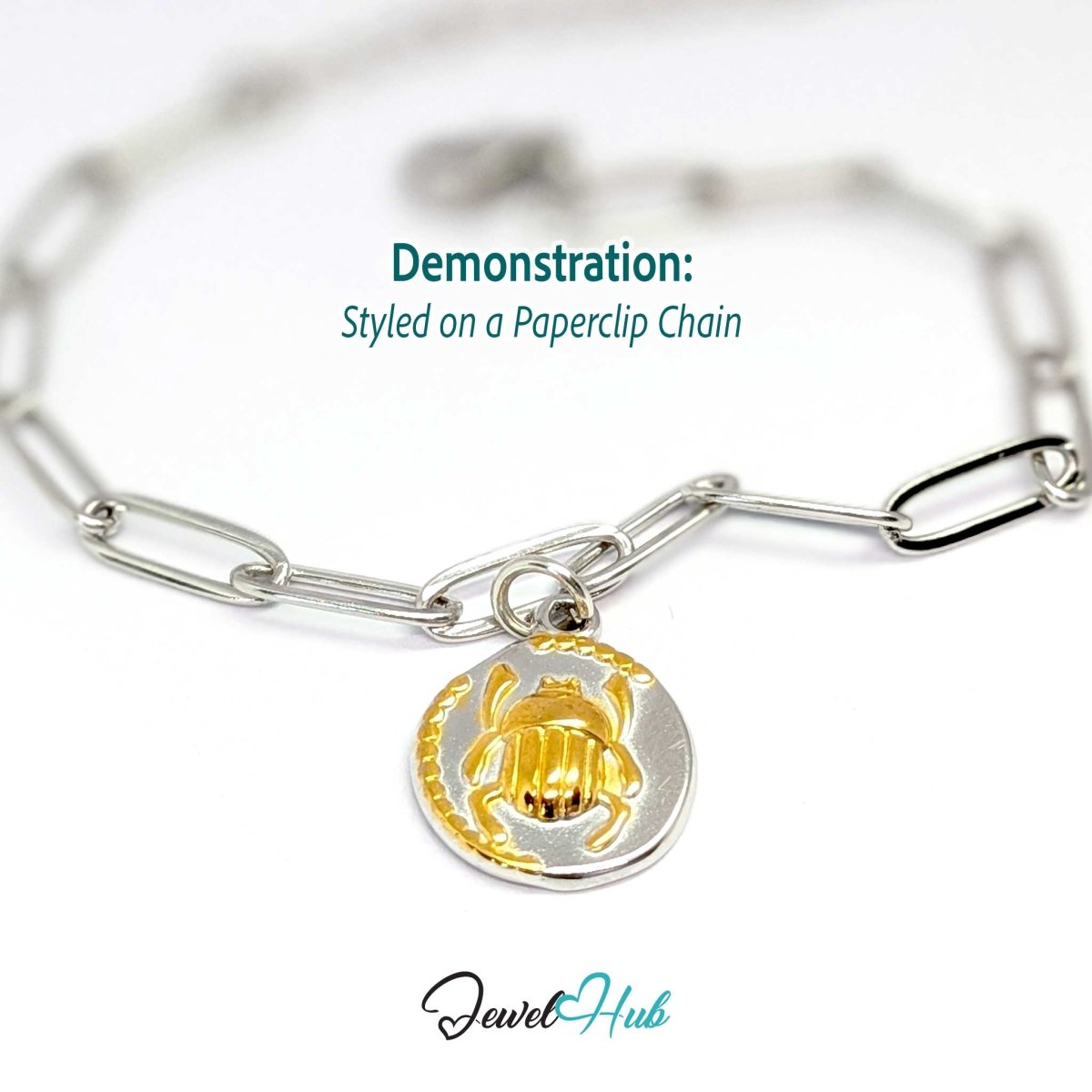 Scarab Oval charm, two-tone stainless steel, styled on a silver paperclip chain bracelet - JewelHub