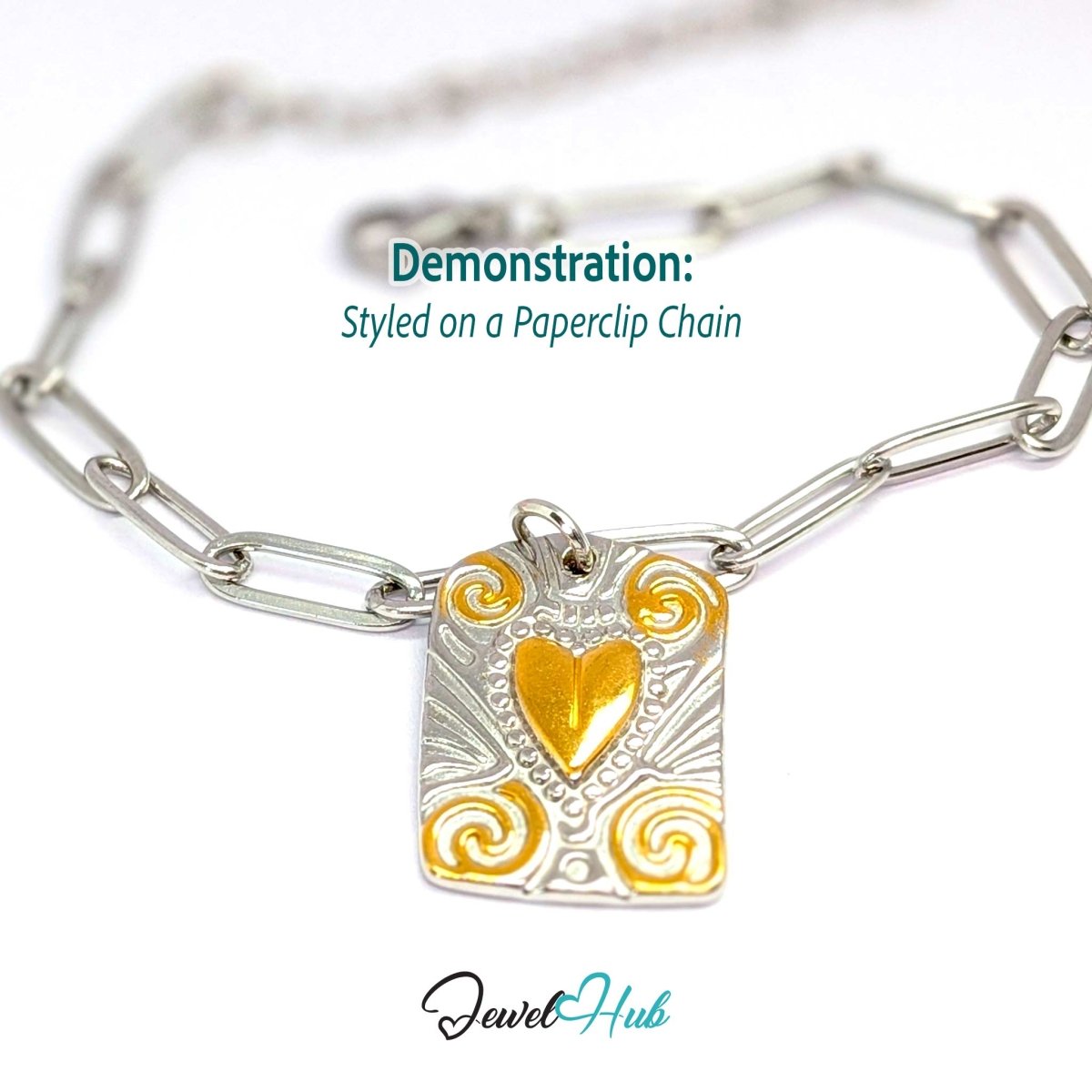 Two-tone Scroll Plaque charm styled on a silver paperclip chain bracelet - JewelHub