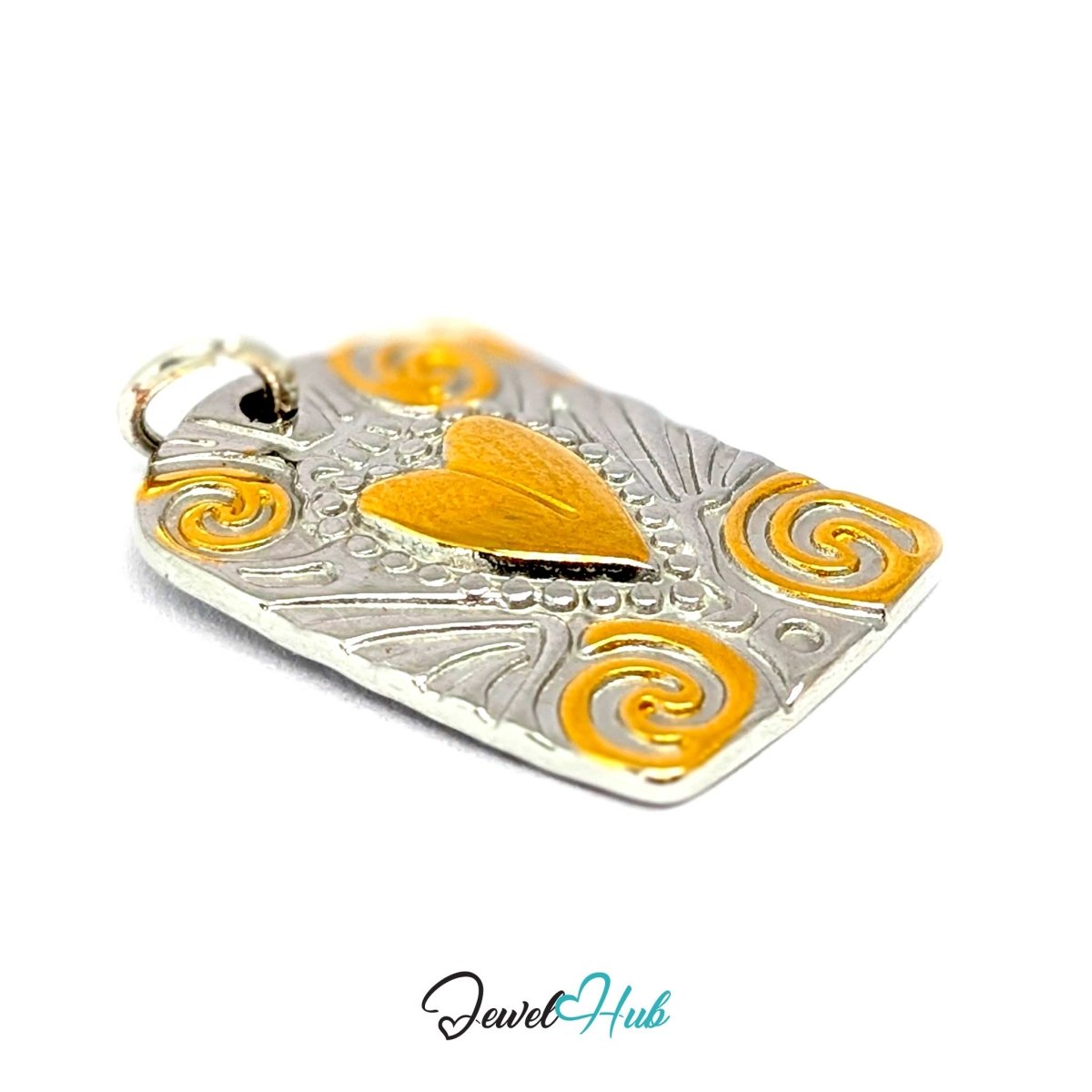 Scroll Plaque charm tilted to show the four gold corner scrolls and the raised gold heart - JewelHub