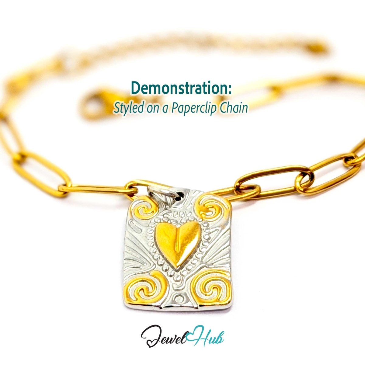 Two-tone Scroll Plaque charm styled on a gold paperclip chain bracelet - JewelHub