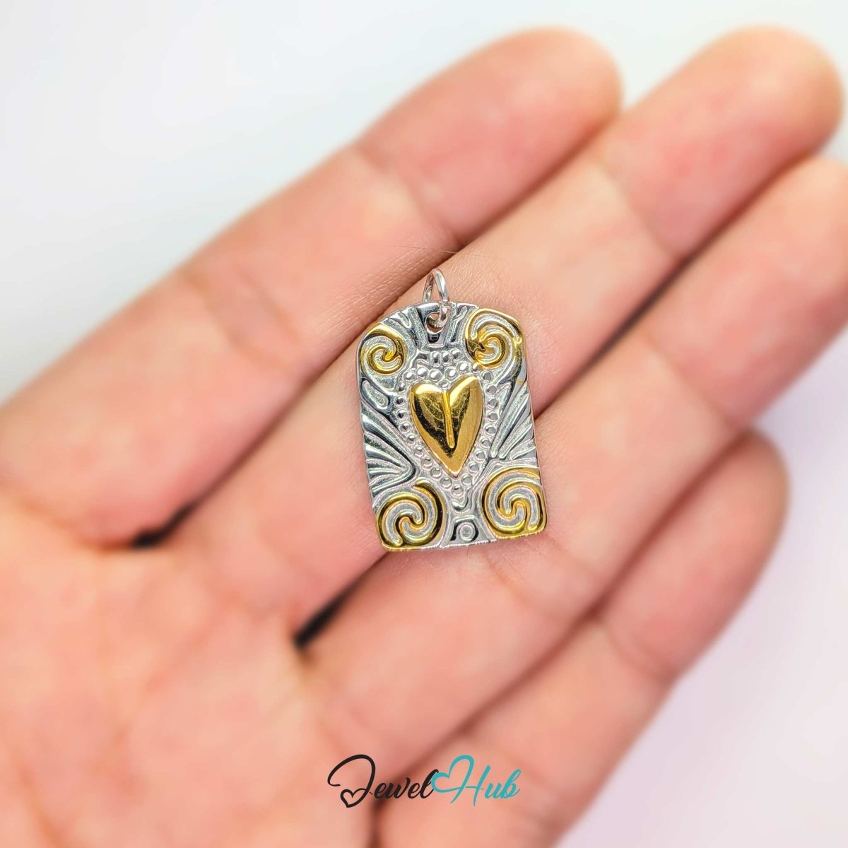 Two-tone Scroll Plaque charm held in the hand to show its 21.5mm height - JewelHub