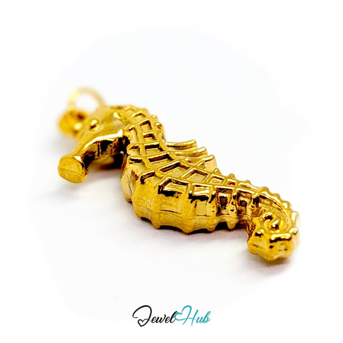 Gold seahorse charm laid horizontally to show its 4.5mm depth - JewelHub