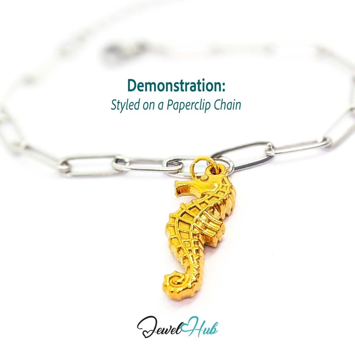 Gold seahorse charm styled on a silver paperclip chain bracelet for a two-tone look - JewelHub