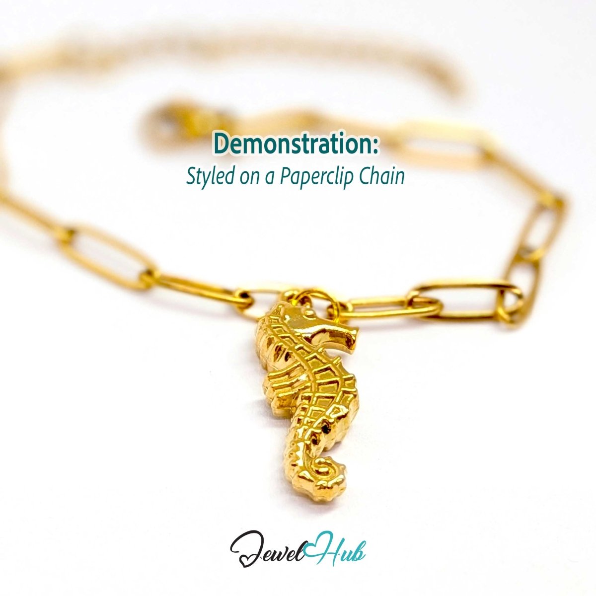Gold seahorse charm styled on a gold paperclip chain bracelet - JewelHub