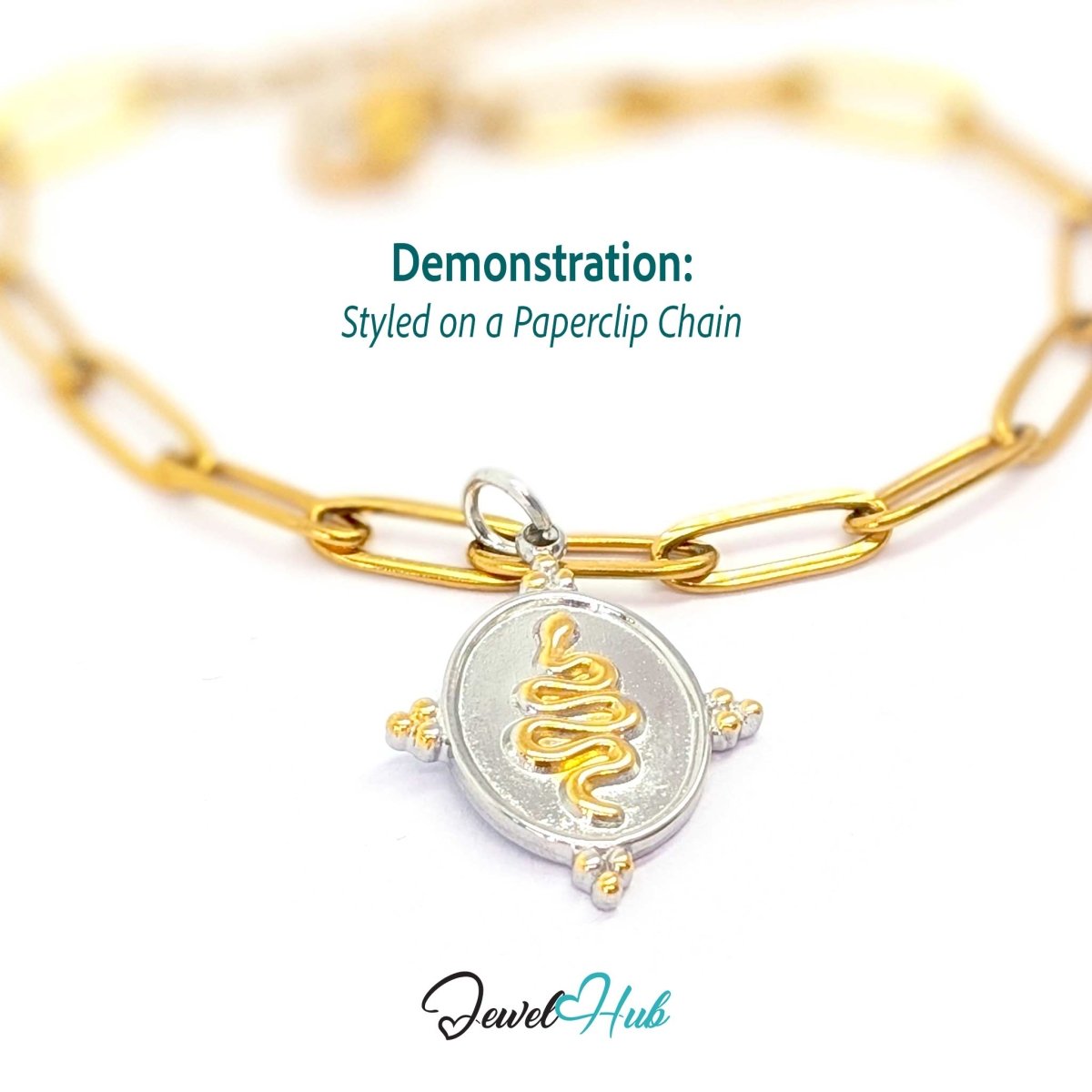 Snake Oval charm, two-tone stainless steel, styled on a gold paperclip chain bracelet - JewelHub