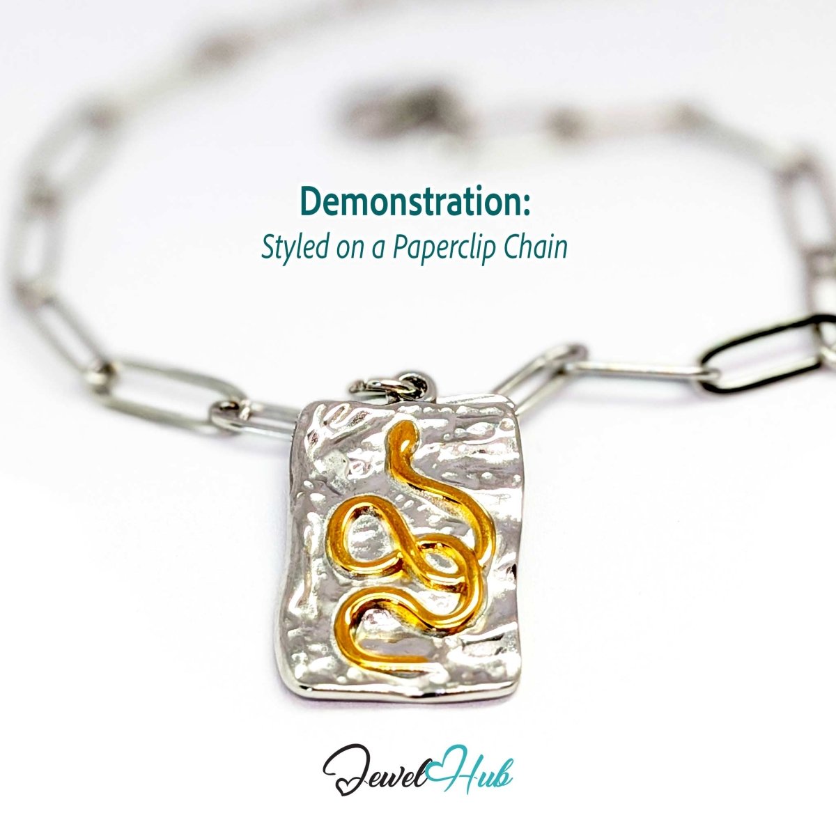 Snake Plate charm, two-tone stainless steel, styled on a silver paperclip chain bracelet - JewelHub