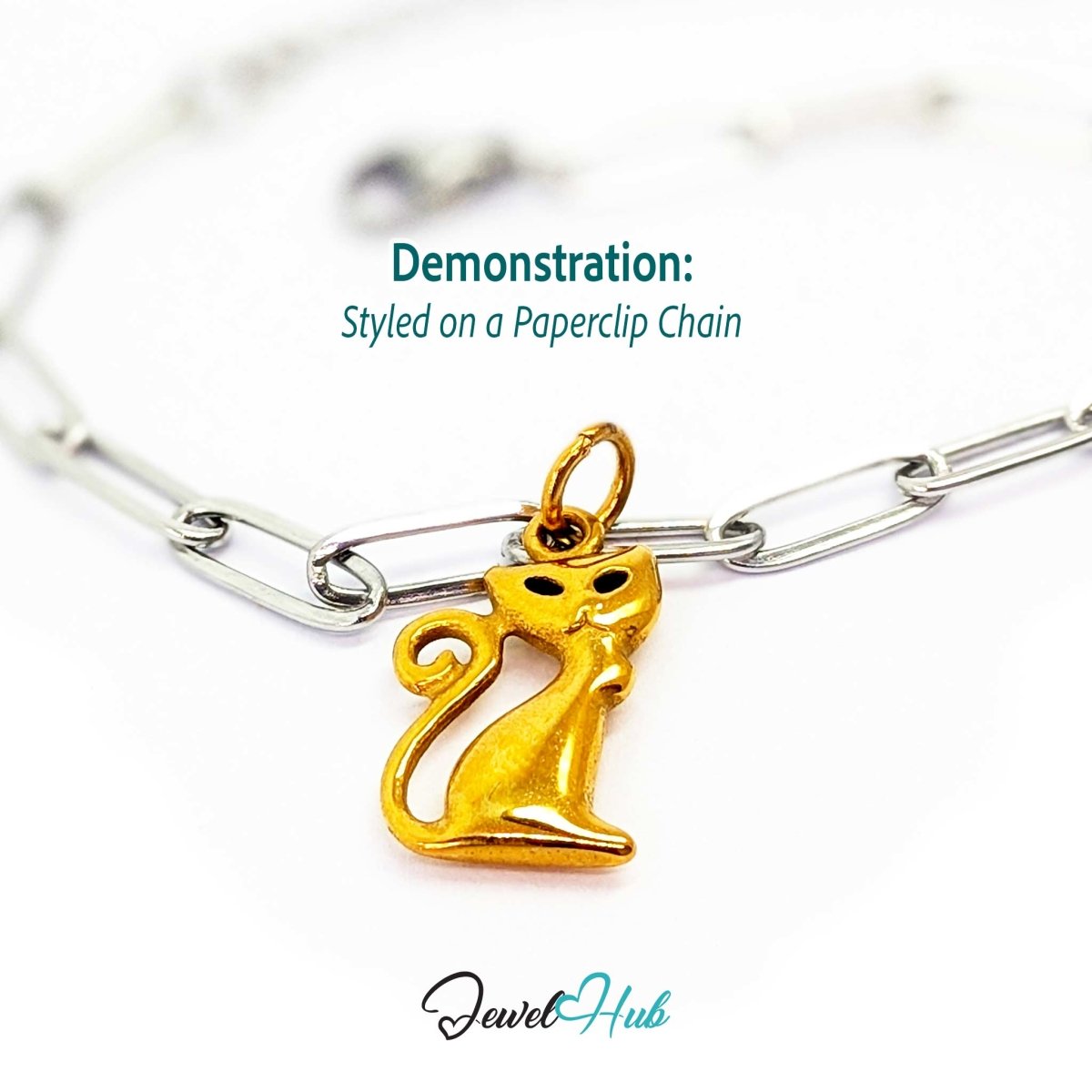 Gold classic standing cat charm styled on a silver paperclip chain bracelet for a two-tone look - JewelHub