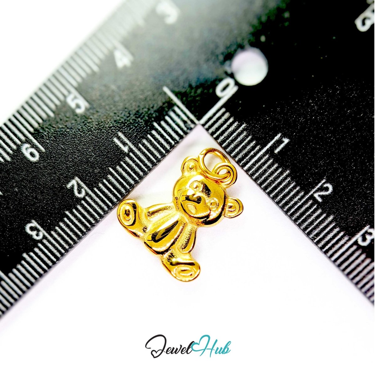 Gold Classic Teddy Bear charm measured against a ruler at 17mm wide by 20mm tall - JewelHub
