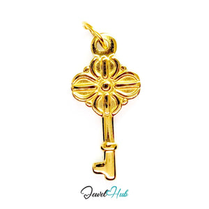 Vintage key charm in gold stainless steel with a quatrefoil bow - front view - JewelHub