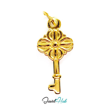 Vintage key charm in gold stainless steel with a quatrefoil bow - front view - JewelHub