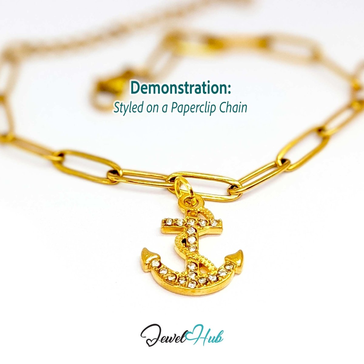 Anchor charm in gold stainless steel with a coiled rope and pave crystals - styled on a gold paperclip chain bracelet - JewelHub