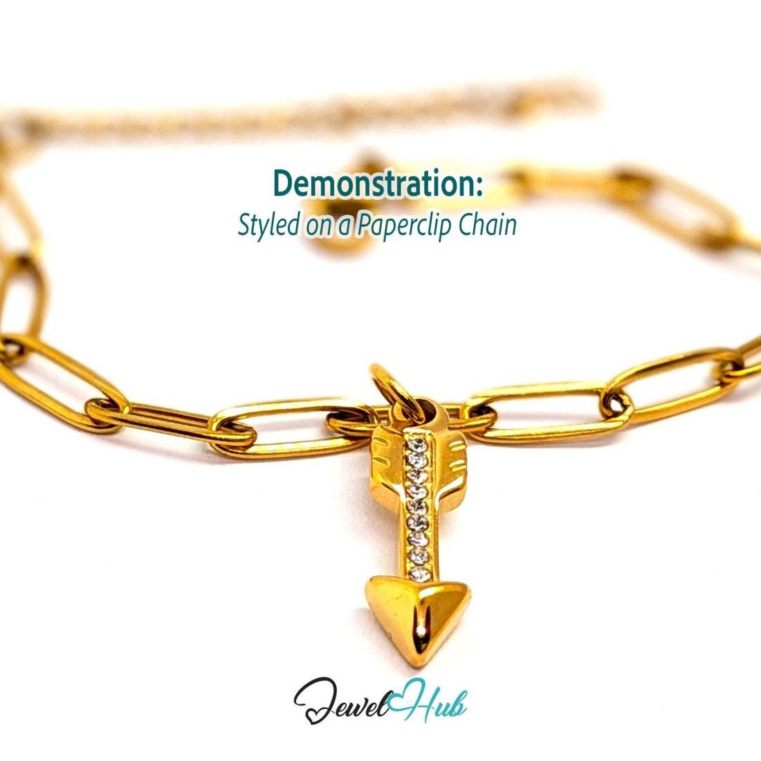 Arrow charm in gold stainless steel with clear crystals - styled on a gold paperclip chain bracelet - JewelHub