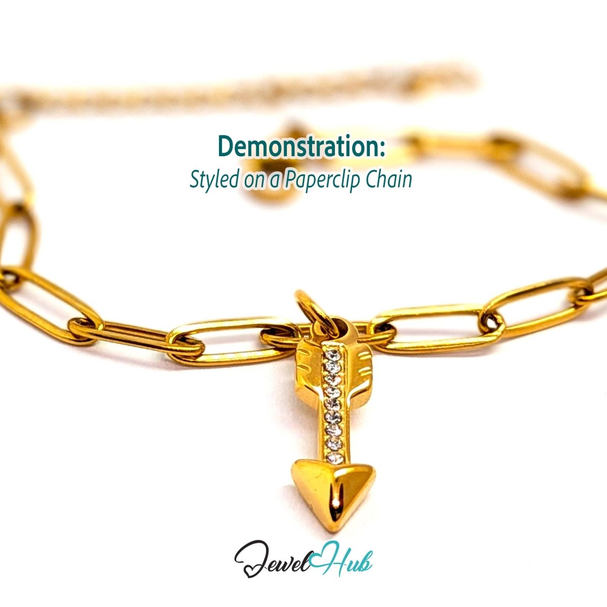 Arrow charm in gold stainless steel with clear crystals - styled on a gold paperclip chain bracelet - JewelHub