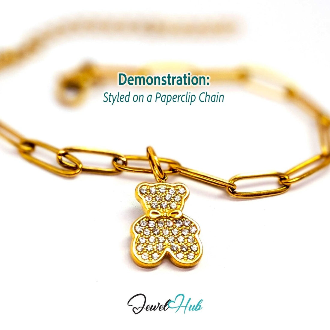 Gold crystal Bow Bear charm styled on a gold paperclip chain bracelet - JewelHub