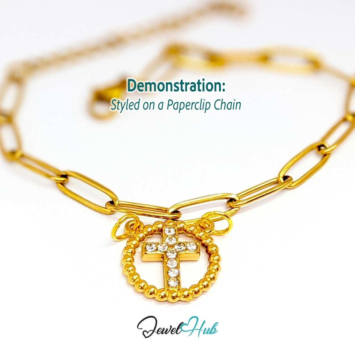 Cross charm in gold stainless steel with ten crystals in a beaded ring - styled on a gold paperclip chain bracelet - JewelHub