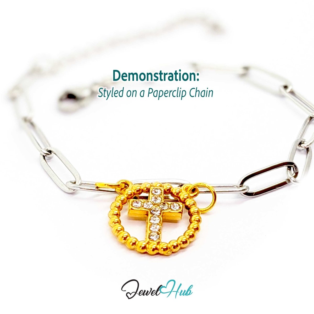 Cross charm in gold stainless steel with ten crystals in a beaded ring - styled on a silver paperclip chain bracelet - JewelHub