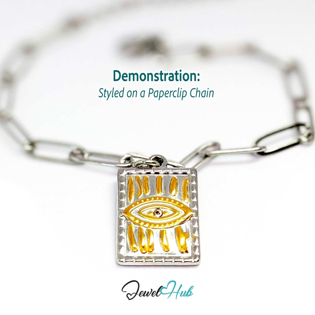 Evil Eye Plate charm, two-tone stainless steel, styled on a silver paperclip chain bracelet - JewelHub