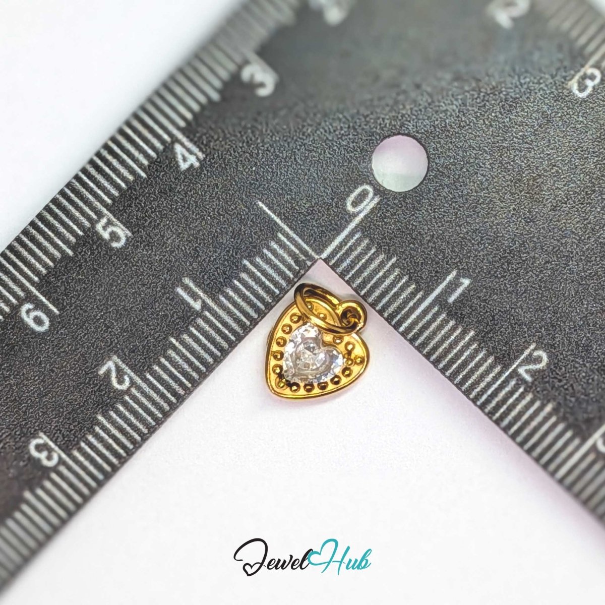 Gem Heart charm, gold stainless steel, measured against a ruler at 9.5 x 12mm - JewelHub