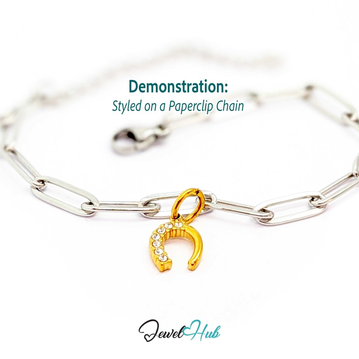 Mini horseshoe charm in gold stainless steel with seven crystals - styled on a silver paperclip chain bracelet - JewelHub