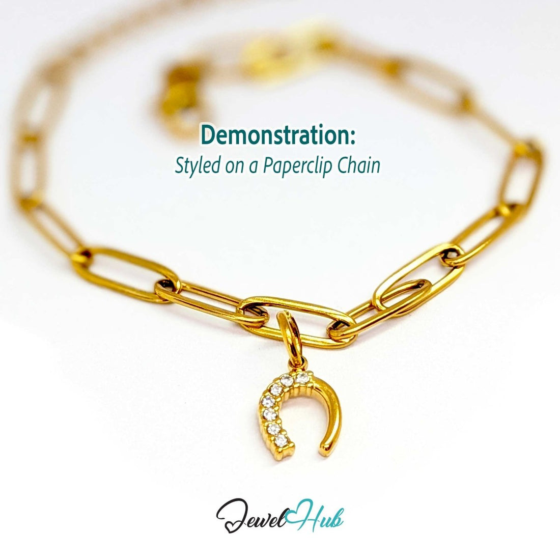 Mini horseshoe charm in gold stainless steel with seven crystals - styled on a gold paperclip chain bracelet - JewelHub
