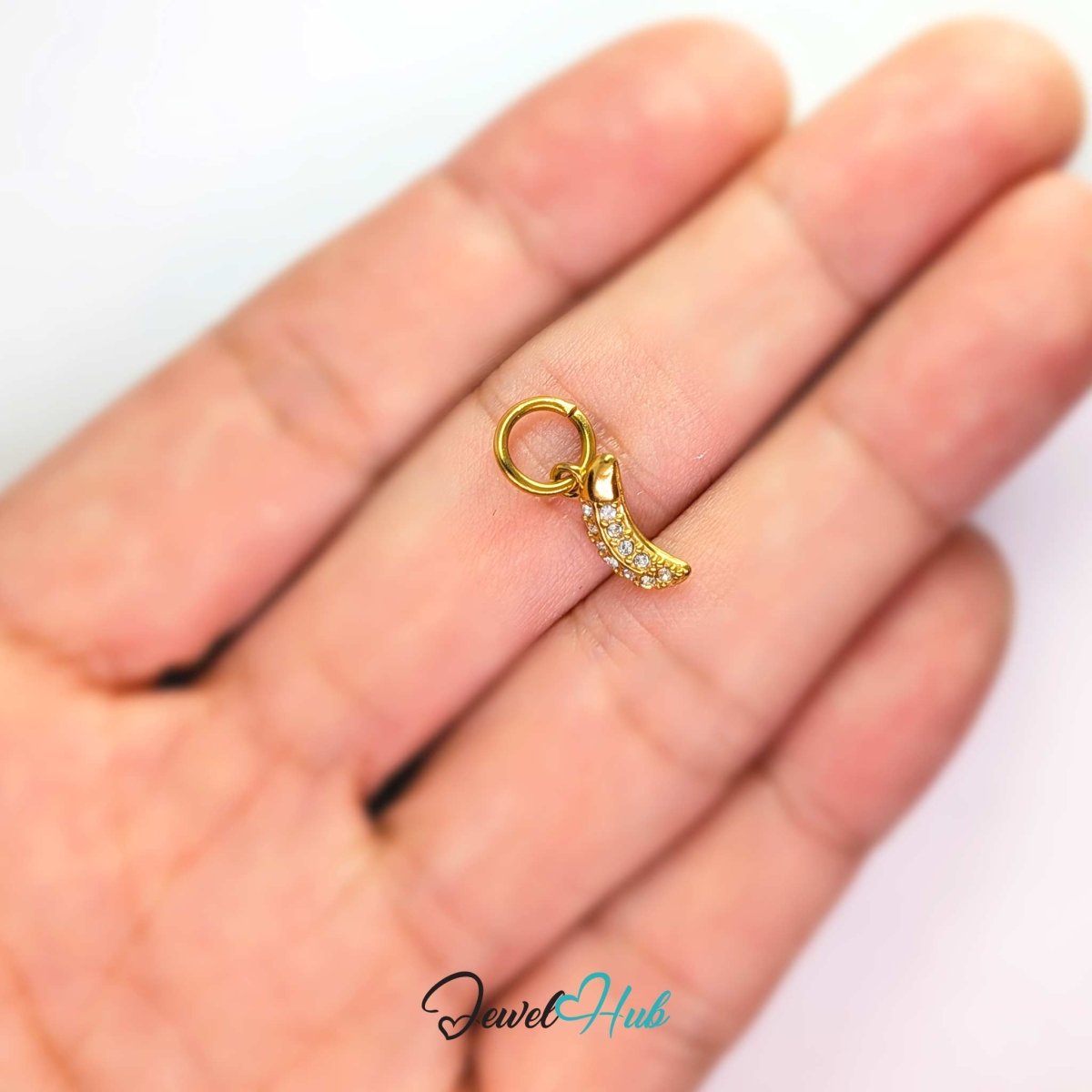 Crystal Mini Moon charm held on a fingertip to show its 10.2mm size - JewelHub