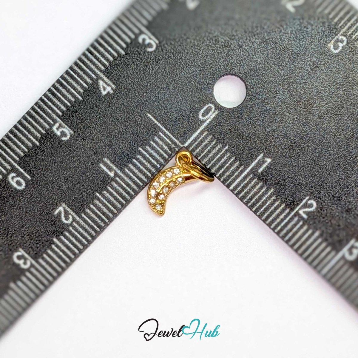 Crystal Mini Moon charm measured against a ruler at 5.5mm wide by 10.2mm tall - JewelHub