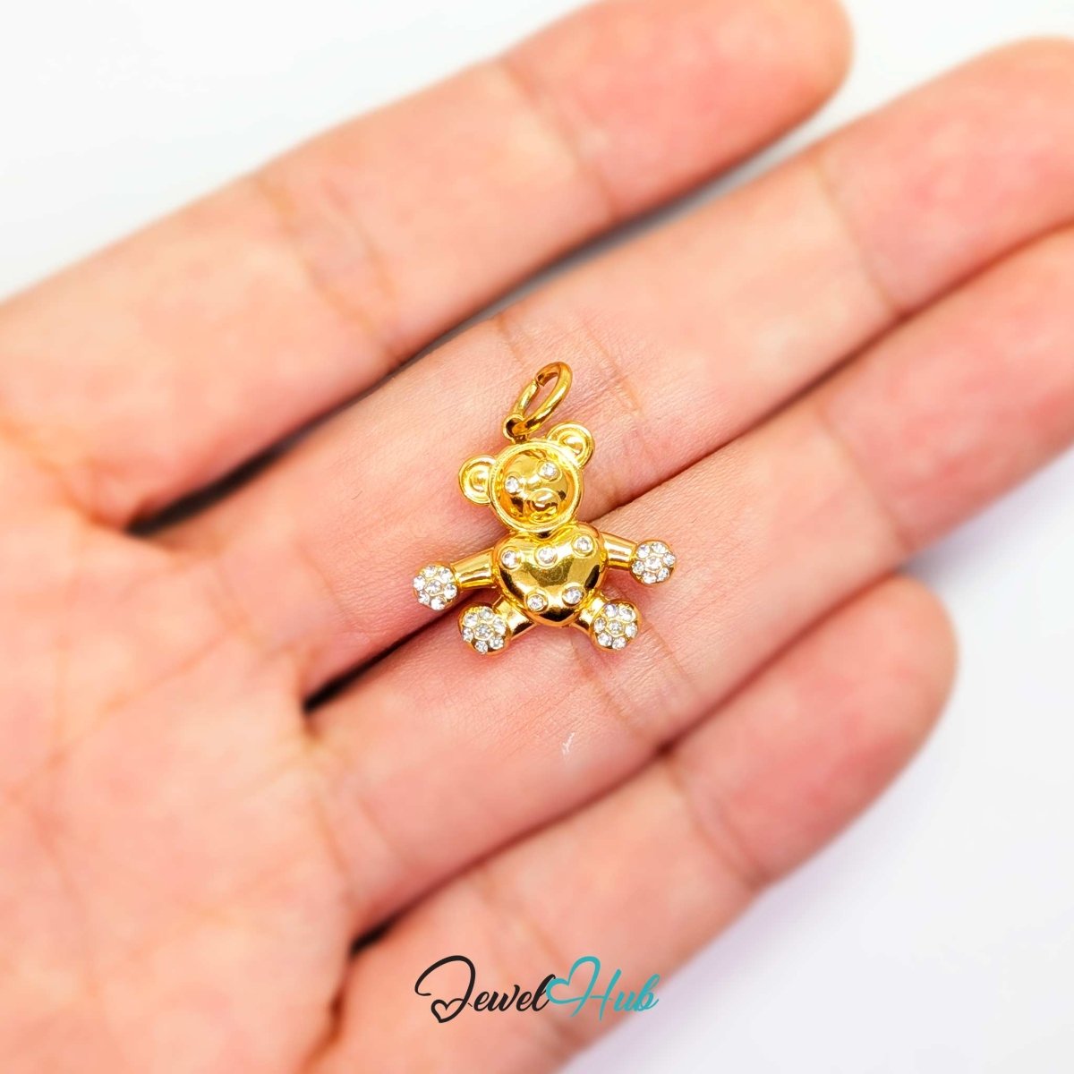 Gold Crystal Open Arms Bear charm held in the hand to show its 18mm width - JewelHub