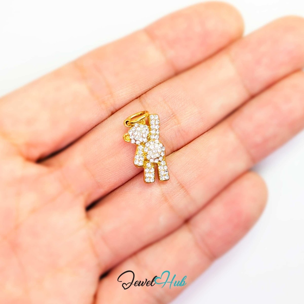 Gold Crystal Petite Bear charm held in the hand to show its tiny 16mm scale - JewelHub
