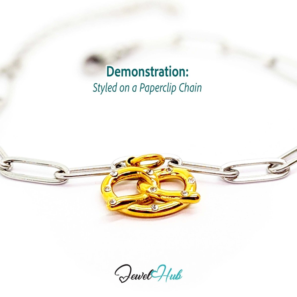 Pretzel charm in gold stainless steel with clear crystals - styled on a silver paperclip chain bracelet - JewelHub