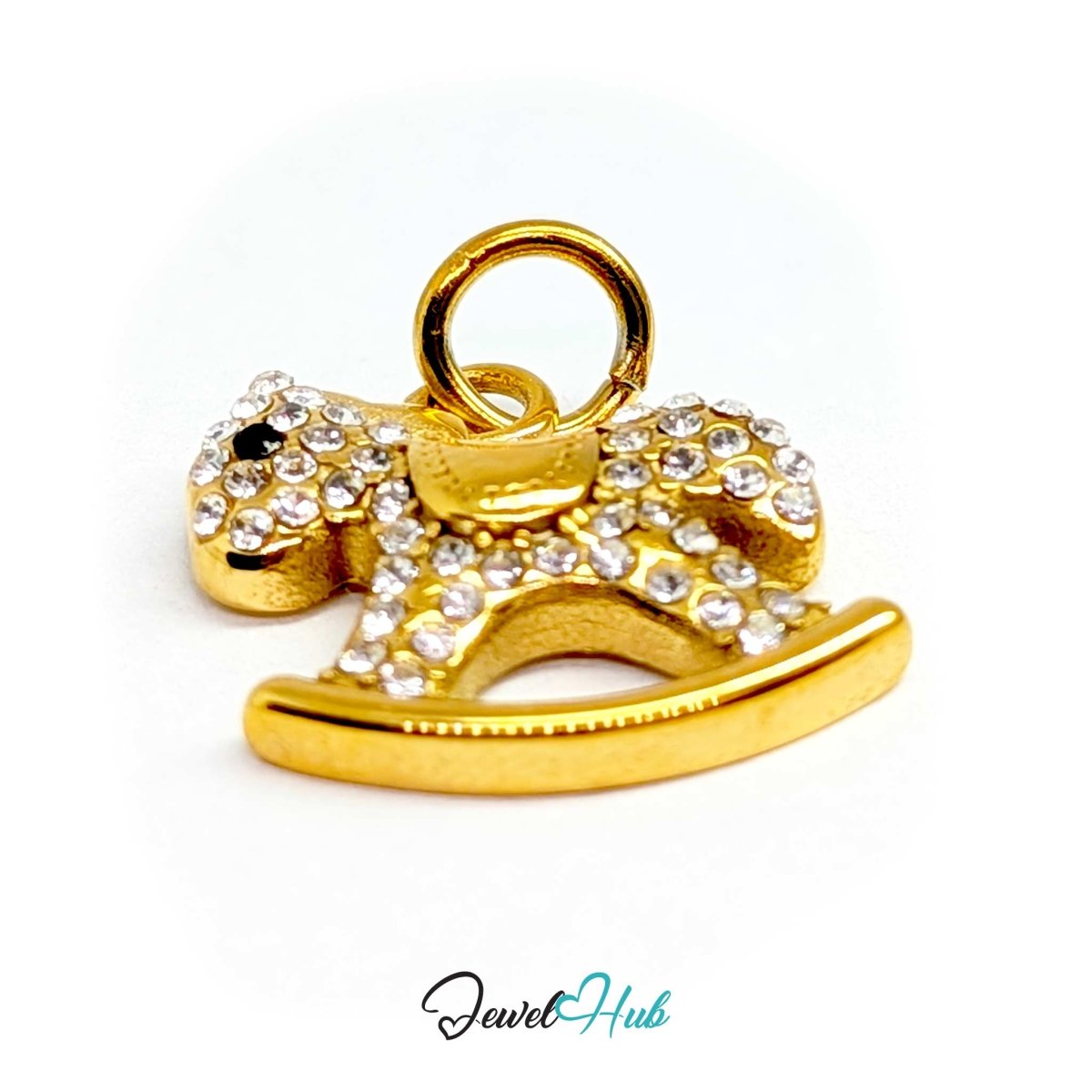 Angled view of the gold Crystal Rocking Horse charm catching light across the crystal-set rocker - JewelHub