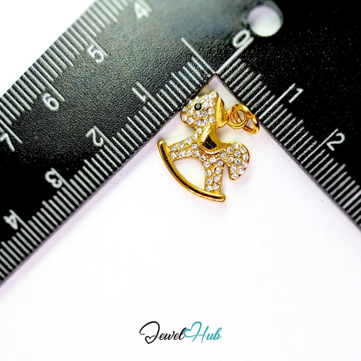 Gold Crystal Rocking Horse charm measured against a ruler at 15.5mm wide by 16.5mm tall - JewelHub