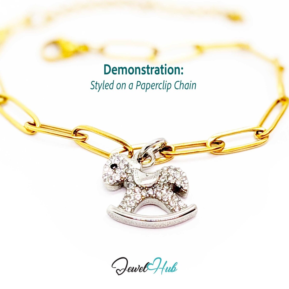 Silver crystal rocking horse charm styled on a gold paperclip chain bracelet for a two-tone look - JewelHub