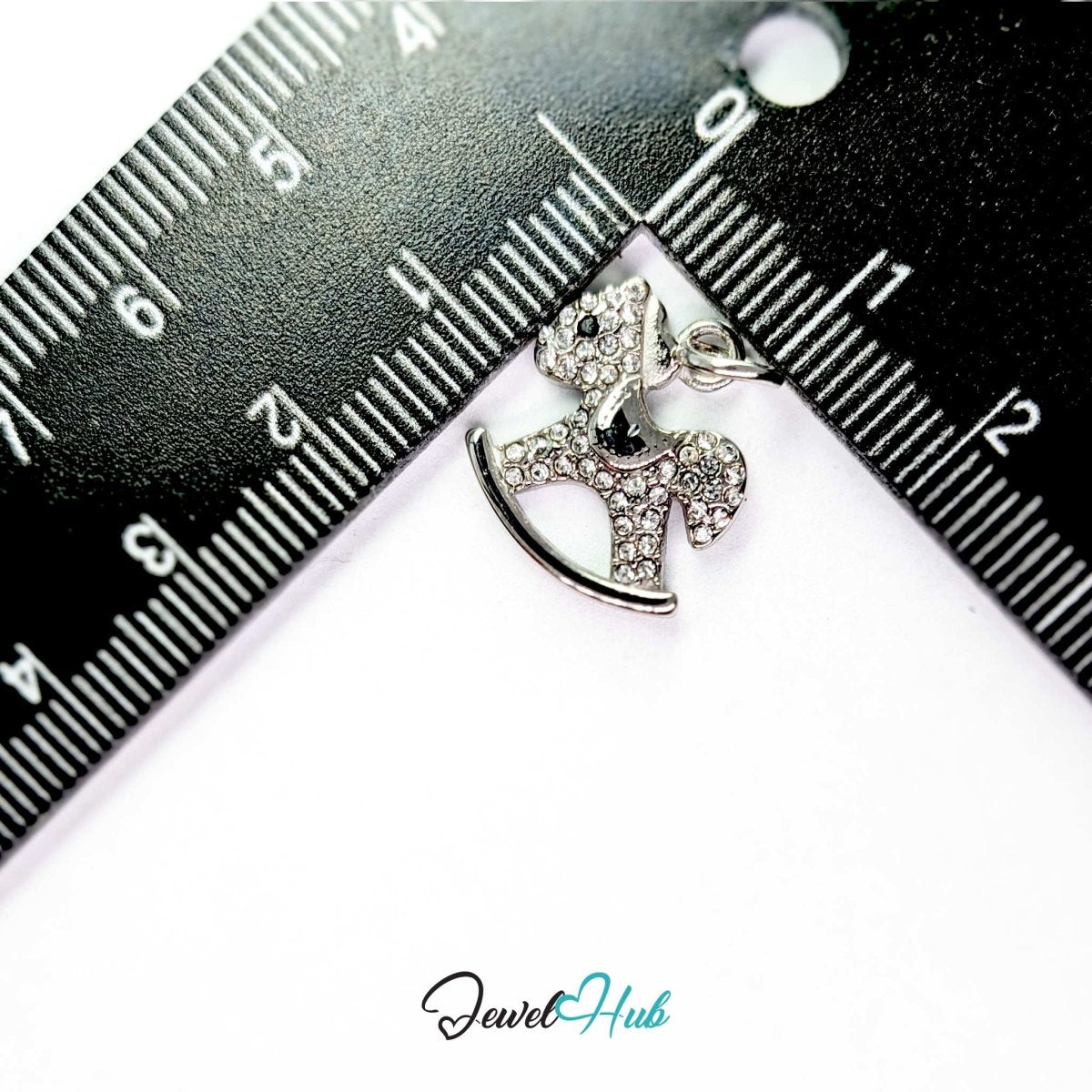 Silver rocking horse charm measured against a ruler at 15.5mm wide by 16.5mm tall - JewelHub