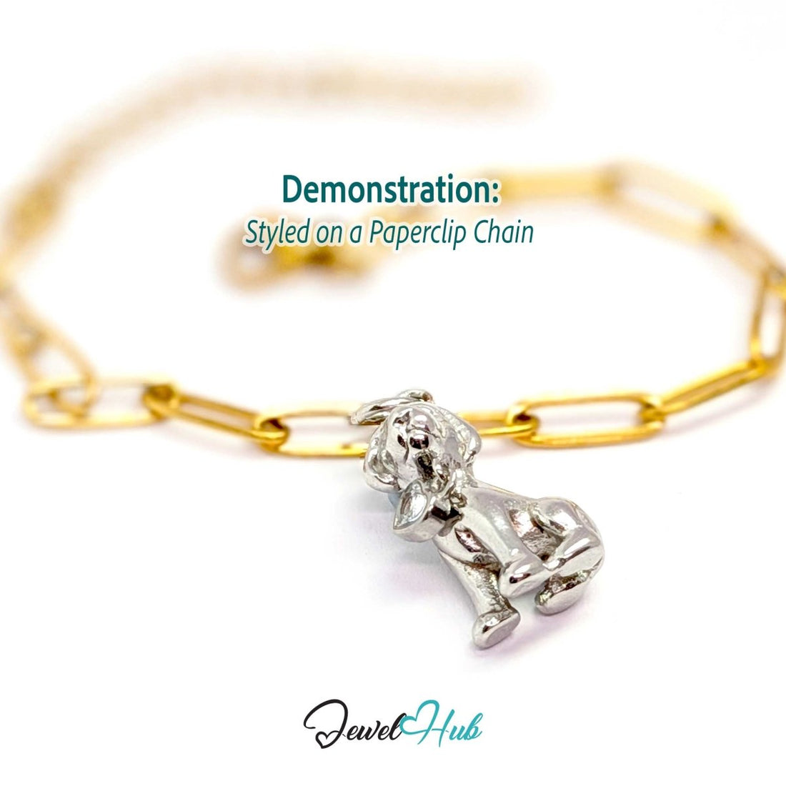 Silver crystal sitting puppy charm styled on a gold paperclip chain bracelet for a two-tone look - JewelHub