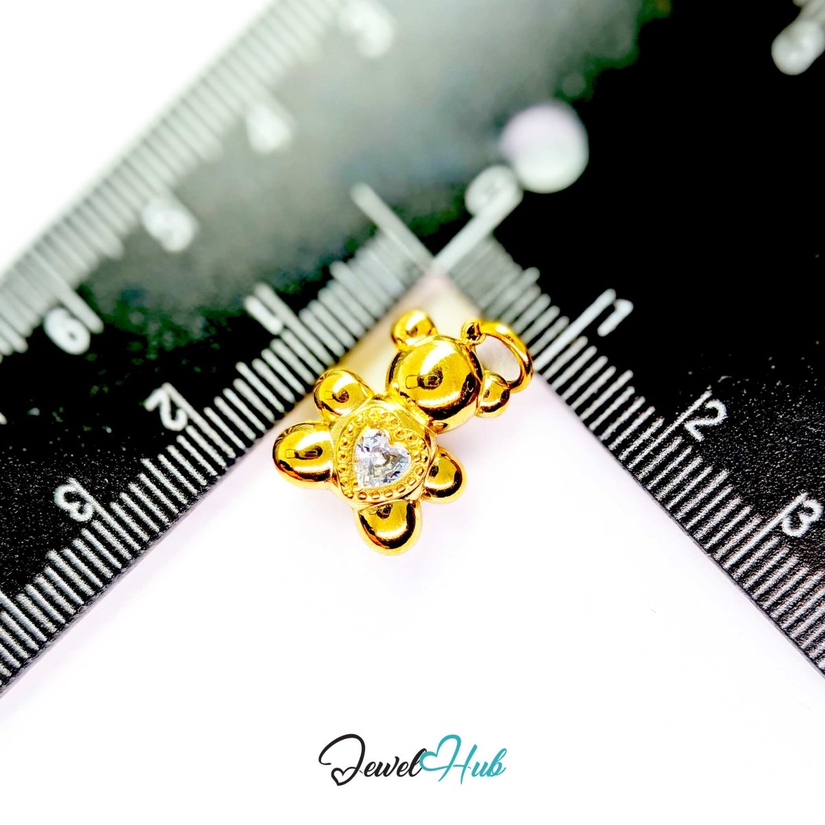 Gold Crystal Solitaire Heart Bear charm measured against a ruler at 13mm wide by 18mm tall - JewelHub
