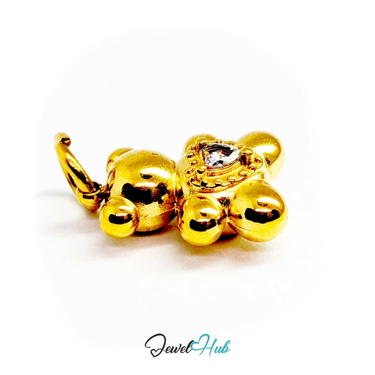 Angled view of the small gold Crystal Solitaire Heart Bear charm with light across the crystal heart - JewelHub