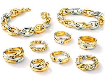 Collection of gold and silver chain-link jewelry on a white background
