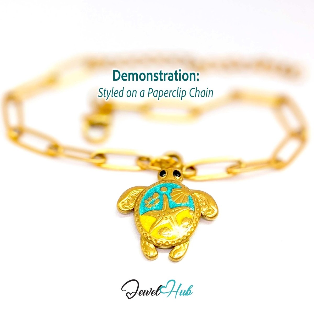 Turquoise enamel sea turtle charm styled on a gold paperclip chain bracelet - JewelHub