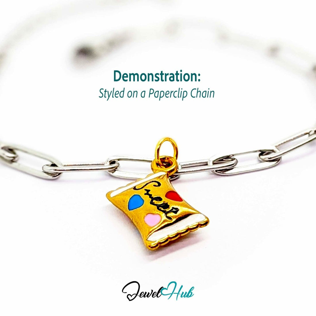 Enamel wrapped sweet charm in gold stainless steel - styled on a silver paperclip chain bracelet - JewelHub