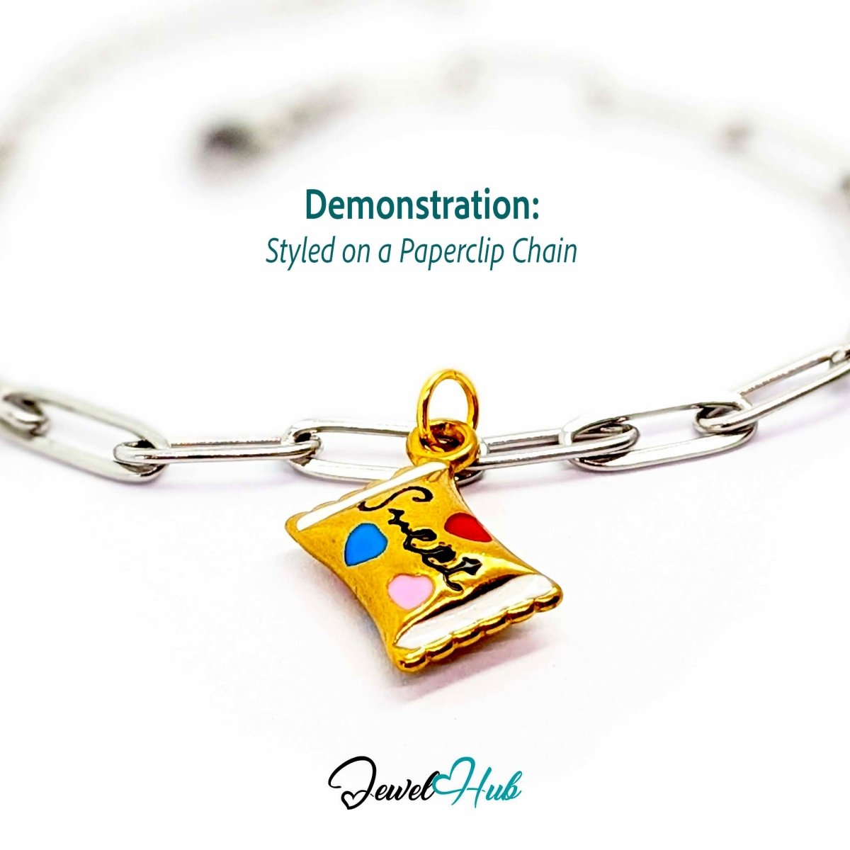 Enamel wrapped sweet charm in gold stainless steel - styled on a silver paperclip chain bracelet - JewelHub