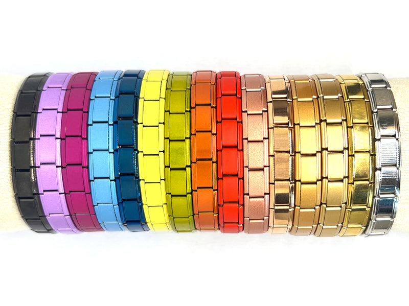 Set of colorful metal bracelets on a white background