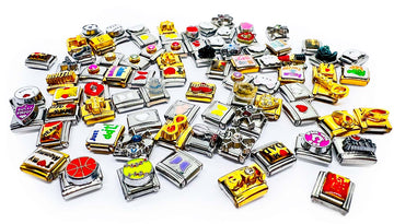 Collection of various small metal charms on a white background