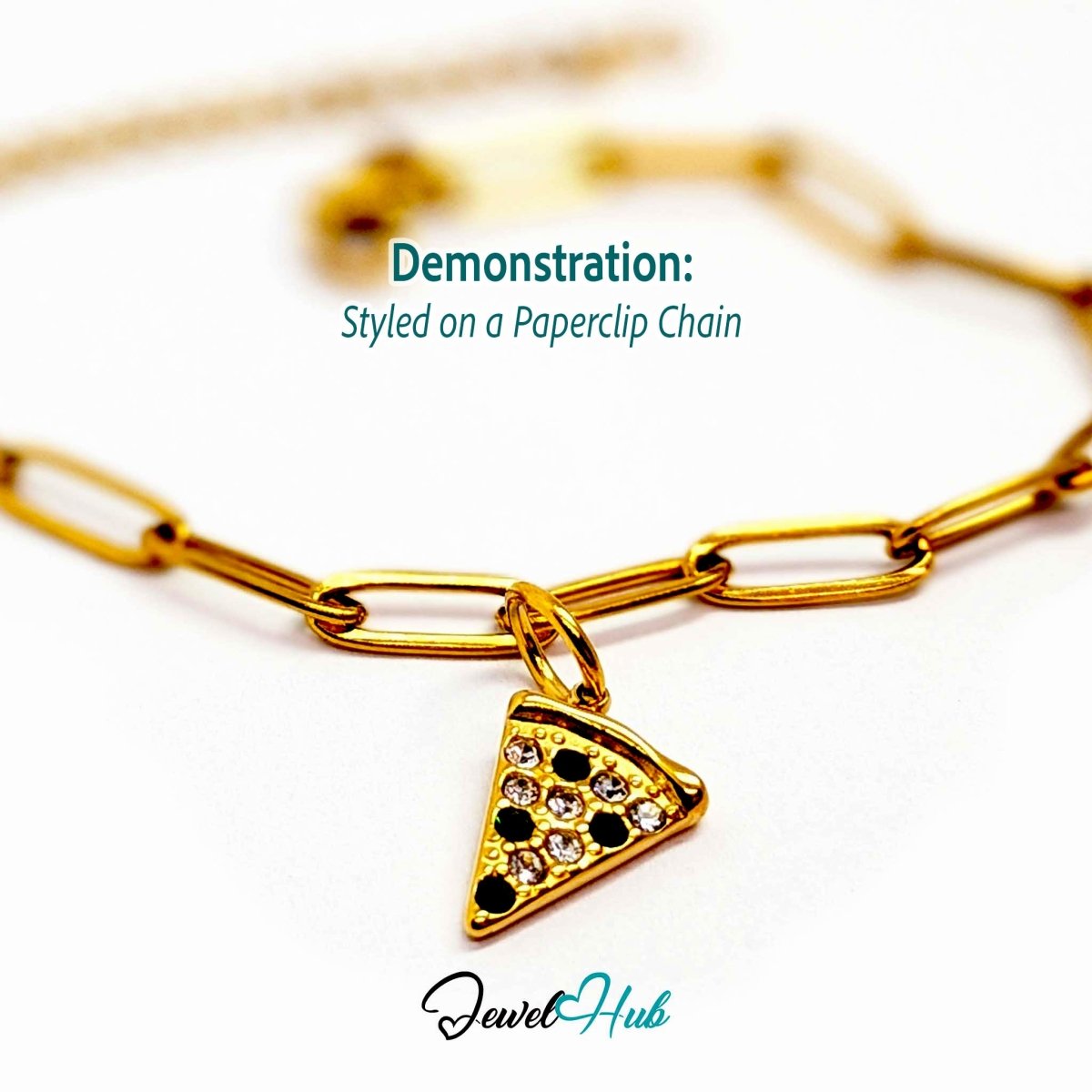 Pizza slice charm in gold stainless steel set with clear and dark green crystals - styled on a gold paperclip chain bracelet - JewelHub