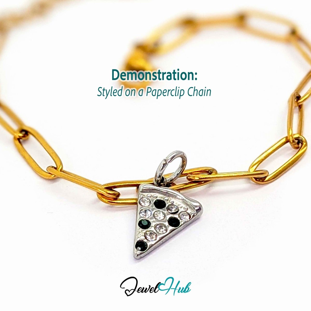 Pizza slice charm in silver stainless steel set with clear and dark green crystals - styled on a gold paperclip chain bracelet - JewelHub