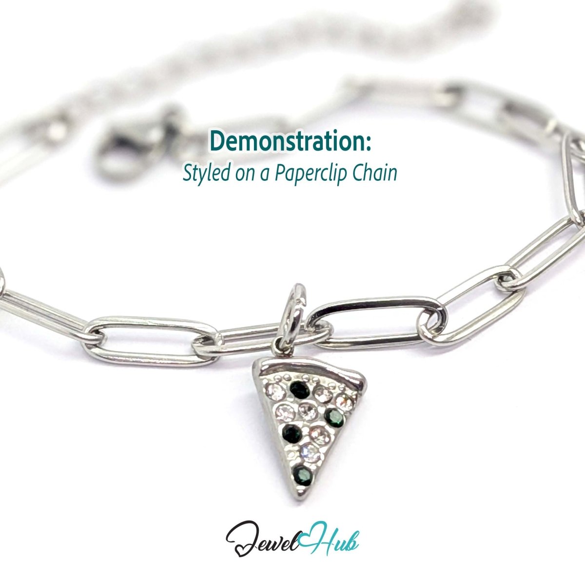 Pizza slice charm in silver stainless steel set with clear and dark green crystals - styled on a silver paperclip chain bracelet - JewelHub