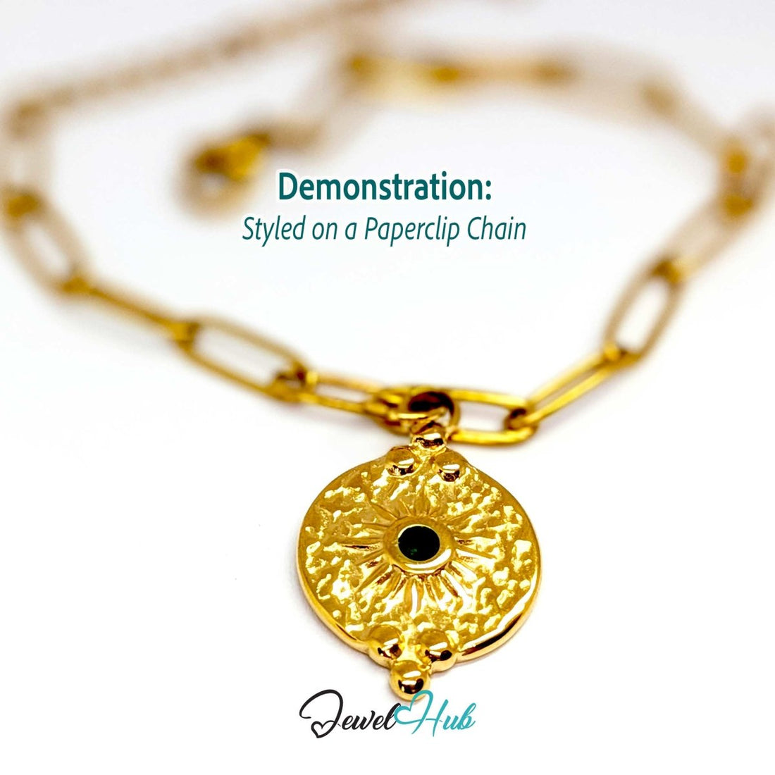 Rosette medallion charm in gold stainless steel with a green gem - styled on a gold paperclip chain bracelet - JewelHub