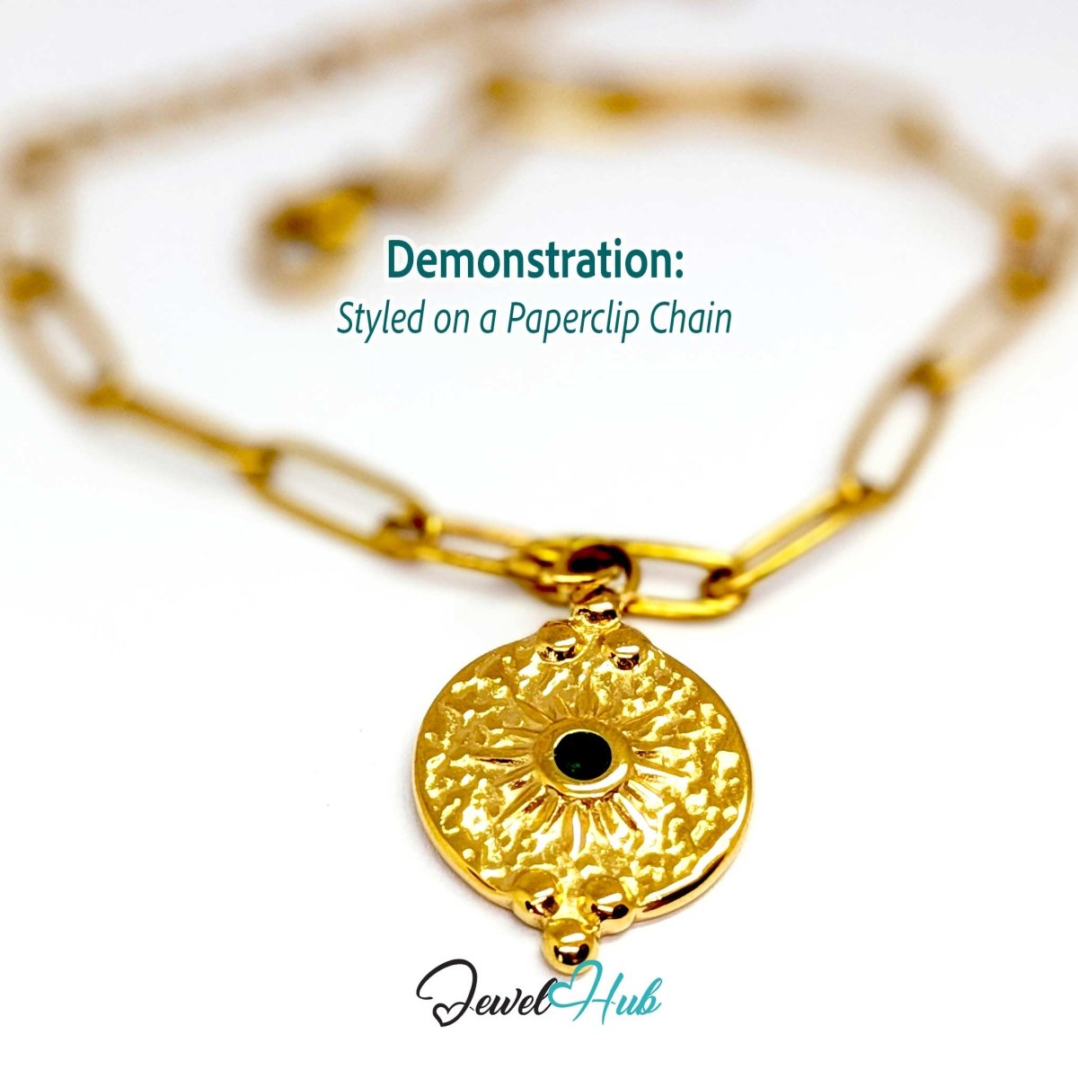 Rosette medallion charm in gold stainless steel with a green gem - styled on a gold paperclip chain bracelet - JewelHub