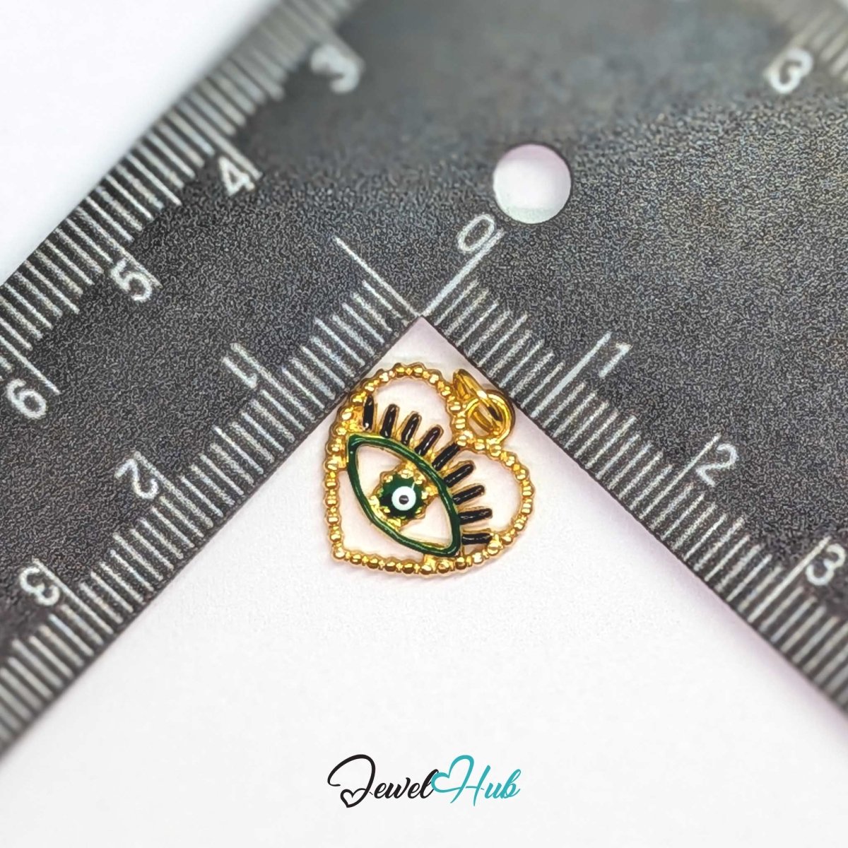 Green Hollow Evil Eye charm, gold stainless steel with enamel, measured against a ruler at 15.2 x 16mm - JewelHub