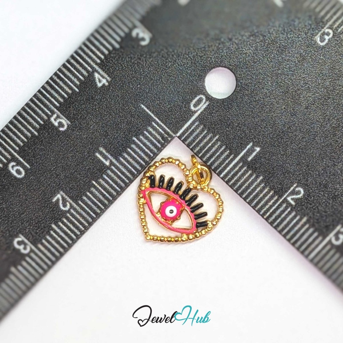 Pink Hollow Evil Eye charm, gold stainless steel with enamel, measured against a ruler at 15.2 x 16mm - JewelHub