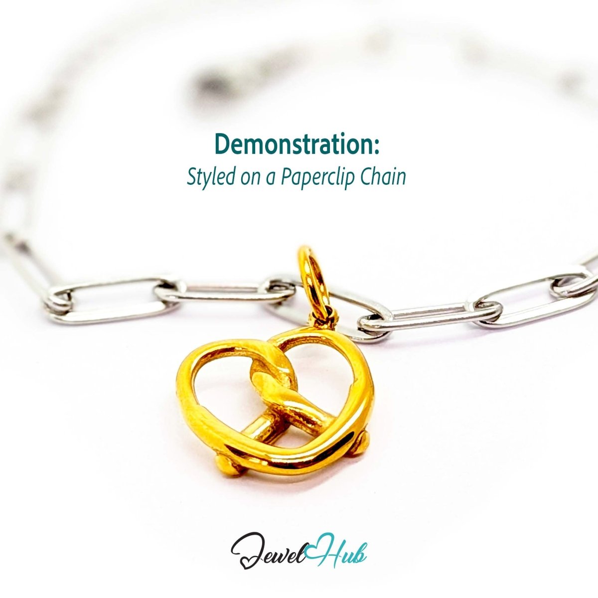 Large openwork pretzel charm in gold stainless steel - styled on a silver paperclip chain bracelet - JewelHub